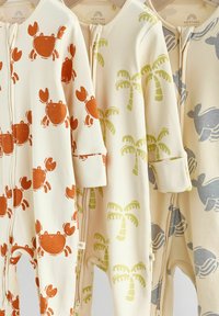 Three baby rompers made of soft material, featuring crab, palm, and whale patterns in orange, green, and blue on cream backgrounds.