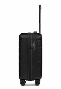 Black hard-shell suitcase with horizontal grooves, combination lock, and retractable handle. Four wheels for mobility. Textured finish.