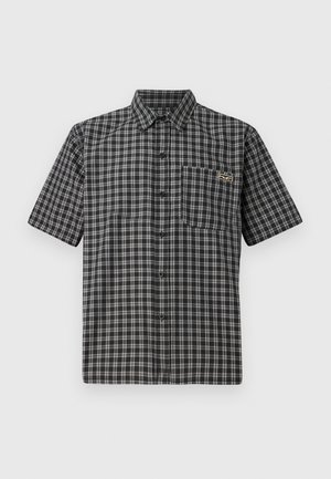 Short-sleeve shirt in black and white plaid pattern, featuring a button-down collar, front pocket, and a small label on the chest.