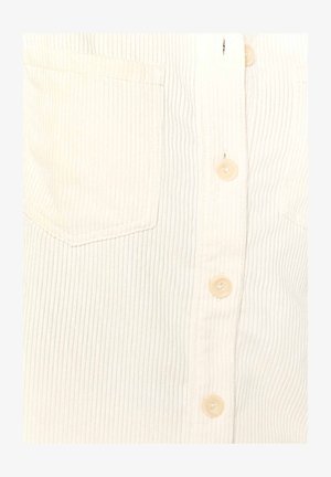 Cream-colored ribbed shirt with a flap pocket, button-front closure, and clear plastic buttons. Visible vertical texture throughout the fabric.