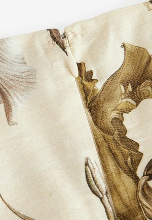Floral print fabric with beige background, featuring a zip closure and textured detailing in brown and gold hues.