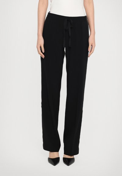 Black wide-leg pants with a relaxed fit, featuring an elastic waistband and drawstring. Material appears soft, smooth texture.