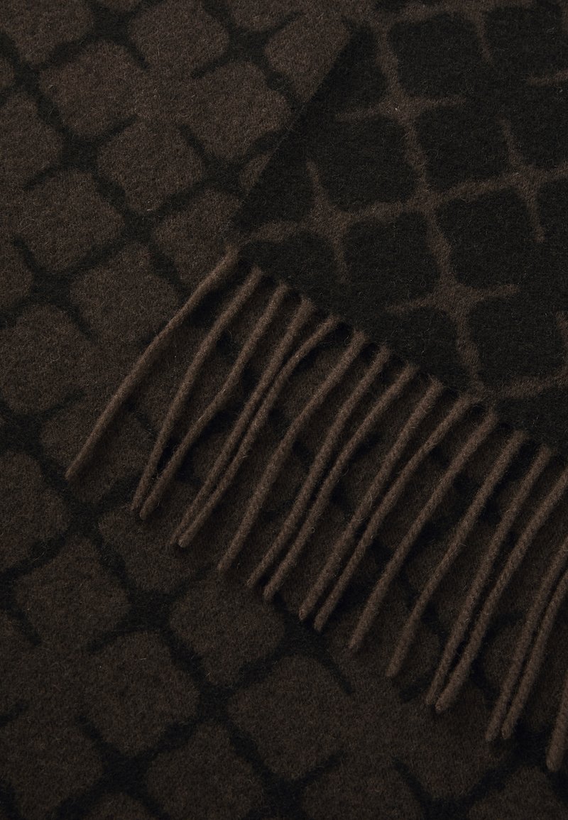Brown patterned wool blanket with a textured geometric design, featuring fringed edges for added detail. Soft and warm to the touch.