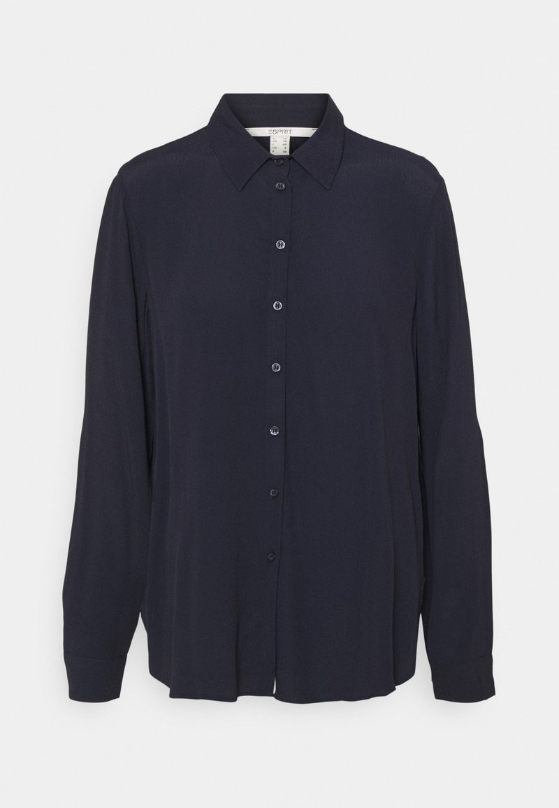 Blouse bleu marine à manches longues, à fermeture boutonnée à l'avant, col classique, texture douce, léger éclat et deux boutonnières aux poignets.