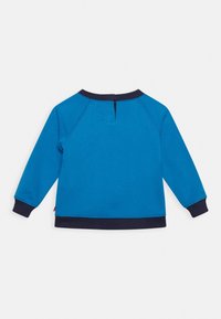 Sudadera azul con puños y bajo de canalé en navy, mangas raglán y apertura en la parte posterior del cuello. Fabricada con una suave tela texturizada.