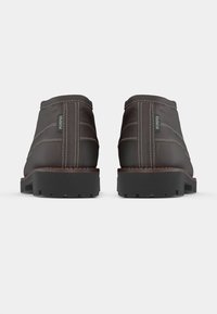 Brune skinn ankelstøvler med kontrasterende hvit søm, gummisåler og et merke på siden som leser "POMPEII." Rund design og lav hæl.