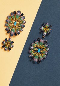Multi-color floral earrings featuring blue, green, and golden rhinestones with a metallic finish. Intricate design and drop-length style.