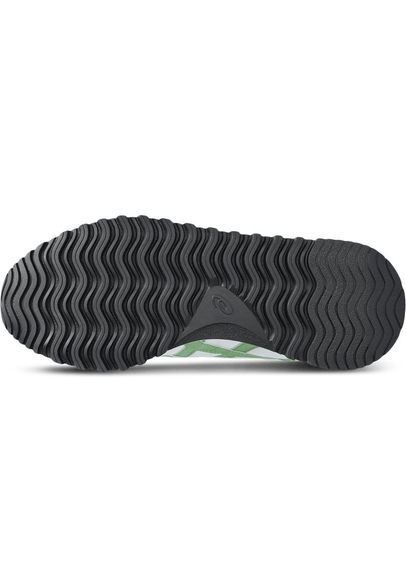 Suela de zapato de goma negra con un patrón de relieve ondulado y un acento verde. Presenta un logo triangular y bordes texturizados para mayor agarre.