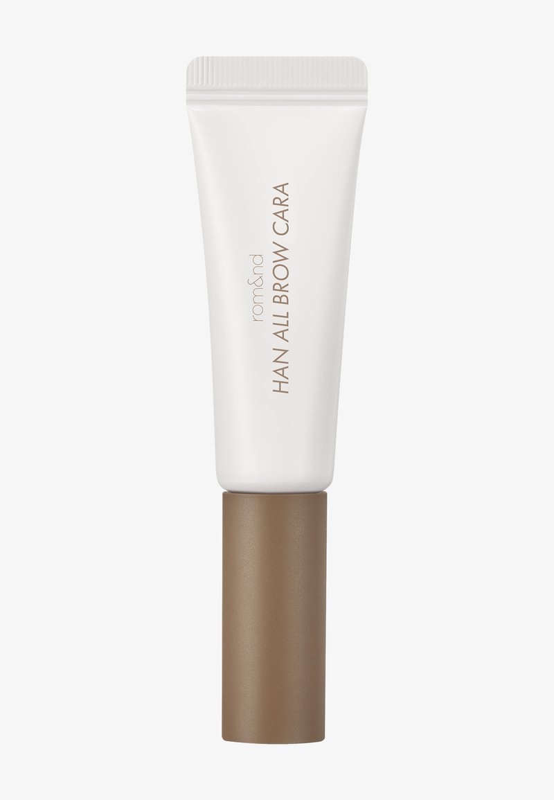 Petit tube blanc et marron de gel à sourcils rom&nd Han All Brow Cara avec texte vertical sur le tube.