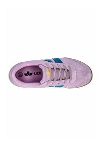 Lilac suede sneaker featuring blue stripes and a textured sole. Interior is purple with a logo. Standard lacing system.