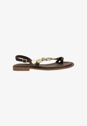 Sandal de plano marrón con diseño de tira entre los dedos, correa ajustable en el tobillo y acentos circulares metálicos decorativos en la parte superior.