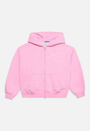 Sweat à capuche zippé rose avec capuche, poches latérales, poignets côtelés et petit logo blanc Nike sur la poitrine sur fond uni.