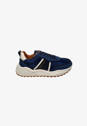 Scarpa da ginnastica blu navy con tomaia testurizzata, dettagli contrastanti bianchi e beige, e suola spessa ammortizzata con battistrada a zigzag.