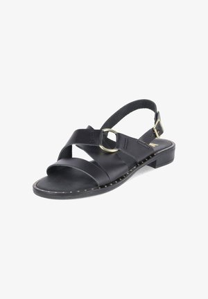 Sandale femme en cuir noir avec bout ouvert, talon bas, brides croisées, détail anneau métallique circulaire et boucle réglable à la cheville.