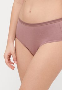Rose-colored cotton brief with a wide elastic waistband. Features smooth texture and simple design, providing full coverage without embellishments.