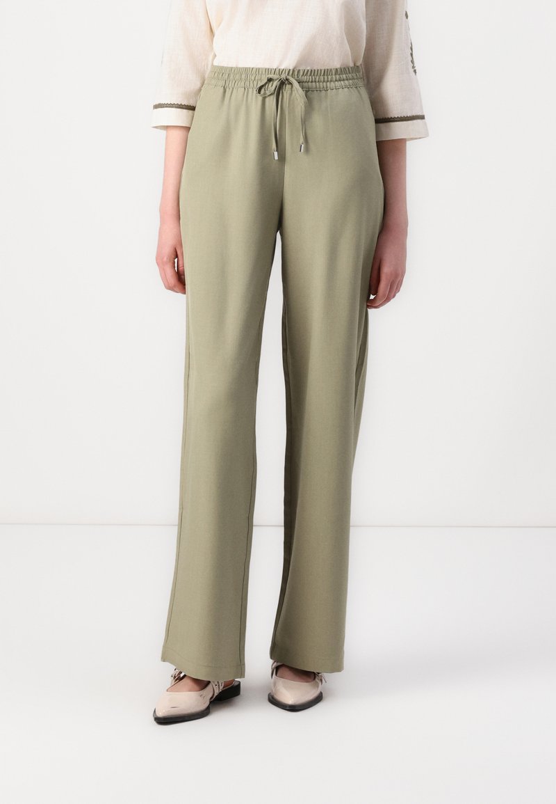 Pantalons vert olive clair en tissu doux, dotés d'une taille élastique avec cordon de serrage, jambes droites et coutures latérales subtiles.