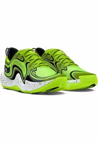 Baskets de sport vert vif avec un design texturé noir, dotées d'une semelle blanche speckled et d'accents verts. Fermeture à lacets à l'avant.