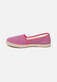 Pink canvas espadrille with a textured upper, contrasting pink trim, and a woven jute sole. Minimalist design with no visible hardware.