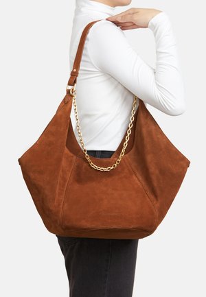 Brown suede shoulder bag with a gold chain accent. Slouchy, oversized design with a smooth texture and no visible logos.
