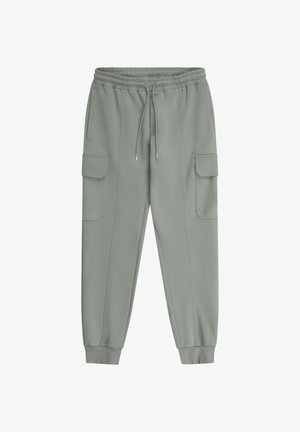 Sive cargo trenirke s elastičnim pojasom, vezicama, bočnim džepovima s poklopcima, suženim nogavicama i elastičnim rubovima na gležnjevima.