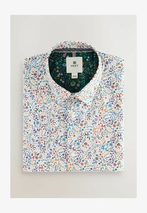 Košulja kratkih rukava sa cvjetnim uzorkom koja ima bijelu osnovu sa šarenim cvjetovima u ljubičastim, narančastim, plavim i zelenim uzorcima. Uključuje zeleni obrub oko ovratnika.