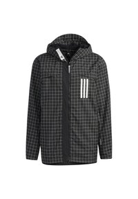 Mustapuku, jossa on ruutukuvio, varustettuna vetoketjulla edessä, hupulla, kahdella rinnassapitokennolla ja kolmella valkoisella raidalla vasemmalla puolella.