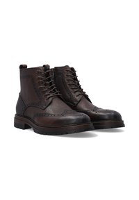 Brązowe skórzane botki z detalami w stylu brogue, z sznurówkami i zamkiem błyskawicznym. Solidne, teksturowane podeszwy oraz zaokrąglony czubek.