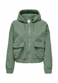 Veste à zip vert en velours côtelé avec une surface texturée, dotée d'une capuche, de deux poches avant à rabat et de poignets élastiques.