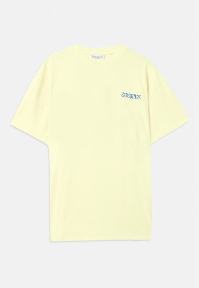 Dzeltena kokvilnas T-kreklu ar brīvu piegriezumu. Uz kreisā krūtis atrodas zils logs. Īsās piedurknes un apaļa izgriezne. Mīksta tekstūra.