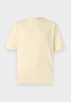 Light yellow cotton t-shirt with a round neckline and short sleeves. Features a subtle, printed logo on the left chest.