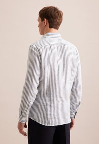 Heren shirt met lange mouwen in lichtblauw en witte verticale strepen, met een button-down kraag en manchetten met één knoop, gemaakt van een gestructureerde stof.