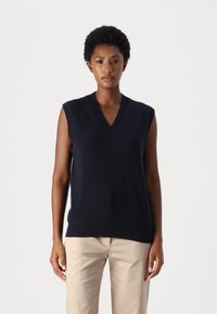 Maglione senza maniche di colore blu navy, realizzato in maglia con un collo a V e orlo a coste. Realizzato in un materiale morbido, presenta un design semplice e pulito.