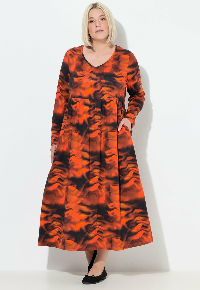 Langärmliges V-Ausschnitt-Kleid mit orange und schwarzem abstraktem Muster. Verfügt über einen entspannten Schnitt mit Taschen und einem fließenden Rock. Glatte Stoffoberfläche.