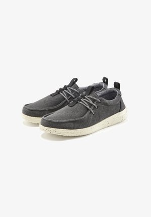 Gray fabric shoes with white speckled soles. Features include black laces with a textured pattern and back pull tabs for easy wear.