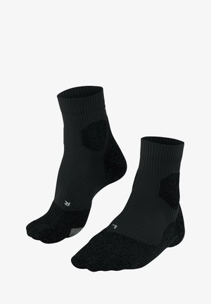 Chaussettes noires de cheville avec une texture côtelée, semelles rembourrées et zones de talon et d'orteil renforcées pour plus de durabilité. Accentuées par un petit logo.