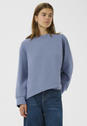 Light blue cropped sweatshirt with an asymmetrical hem, ribbed cuffs, and a round neck, made from a soft cotton blend fabric.
