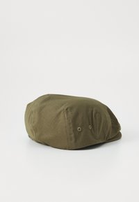 Olive green fabric cap with a rounded shape. Features stitching details and two ventilation holes on the side. Soft texture.