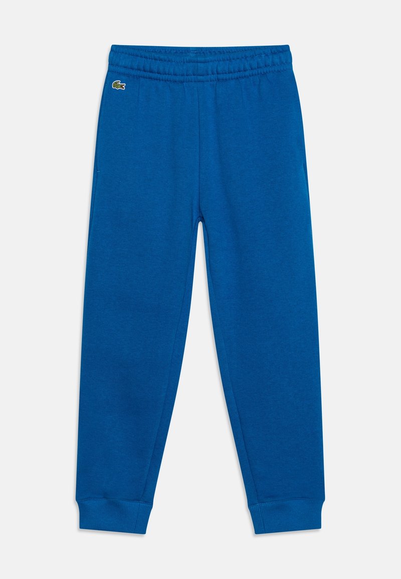 Blå fleecebyxor med elastisk midja, uppvikta fållar och sidofickor. Har en liten grön logotyp på framsidan.