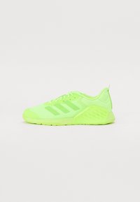 Neon green athletic shoes with mesh upper, three stripes design on the side, textured heel, and flexible rubber sole for traction.