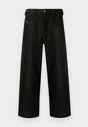 Calças de ganga largas e pretas, com fecho de correr, cinco bolsos e uma marcação discreta no bolso da frente. Tecido durável e texturizado.