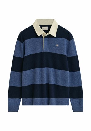 Pull à rayures bleu marine et bleu clair avec un col crème, fabriqué en matériau doux. Présente un petit logo brod�é sur la poitrine.