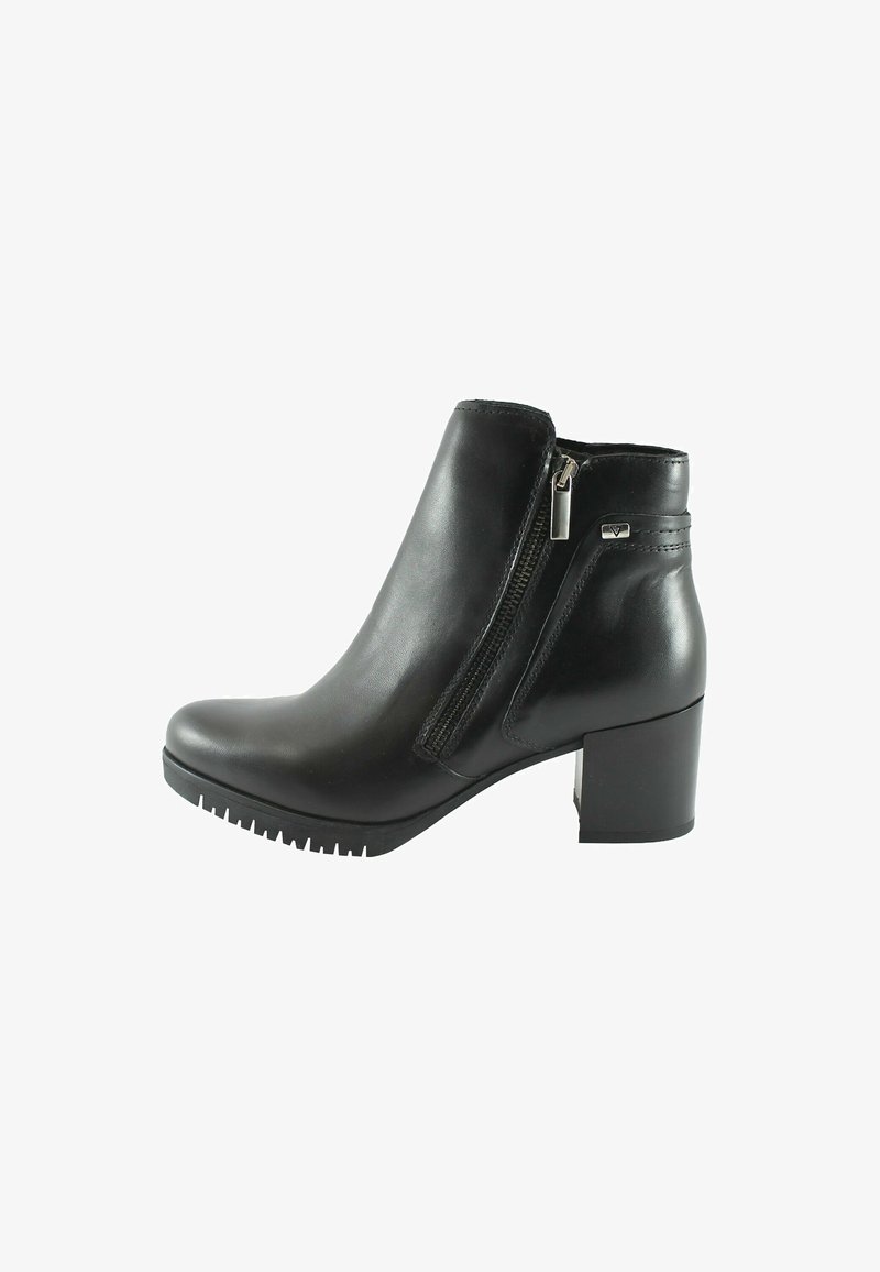 Bottine en cuir noir avec talon bloc, fermeture éclair latérale et semelle texturée, montrée de profil sur fond blanc.