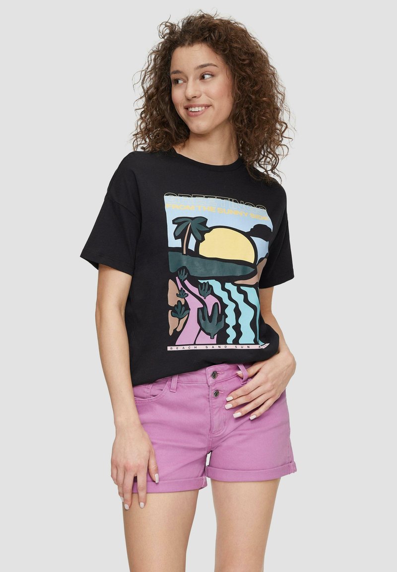 Black cotton t-shirt with colorful beach-themed graphic, paired with light purple denim shorts. Short sleeves and relaxed fit.