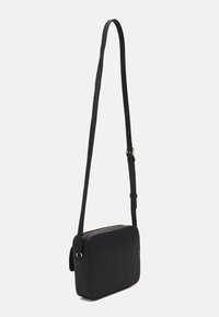 Borsa a tracolla nera in pelle rettangolare con tracolla regolabile e chiusura superiore con zip, esposta su uno sfondo bianco.