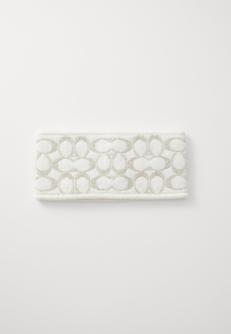 Λευκή πετσέτα με υφή και μπεζ λουλουδάτο σχέδιο. Ορθογώνιο σχήμα με μαλακό, χνουδωτό υλικό και καθαρές άκρες.