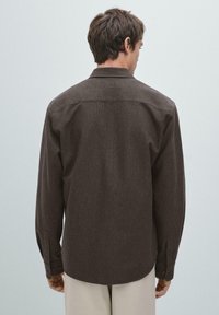 Brown long-sleeve shirt with a relaxed fit, button cuffs, and a smooth texture, featuring a classic collar and a subtle heather pattern.