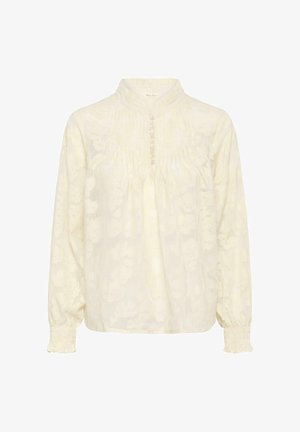 Kreemjas pika varrukaga pluus kõrge volangikraega, esikinnis nööpidega, õrn flores jakkardmustri ja elastsete varrukasäärtega.