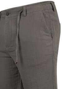 Gray lightweight pants made of textured fabric, featuring an elastic waistband, drawstring, and side pockets.