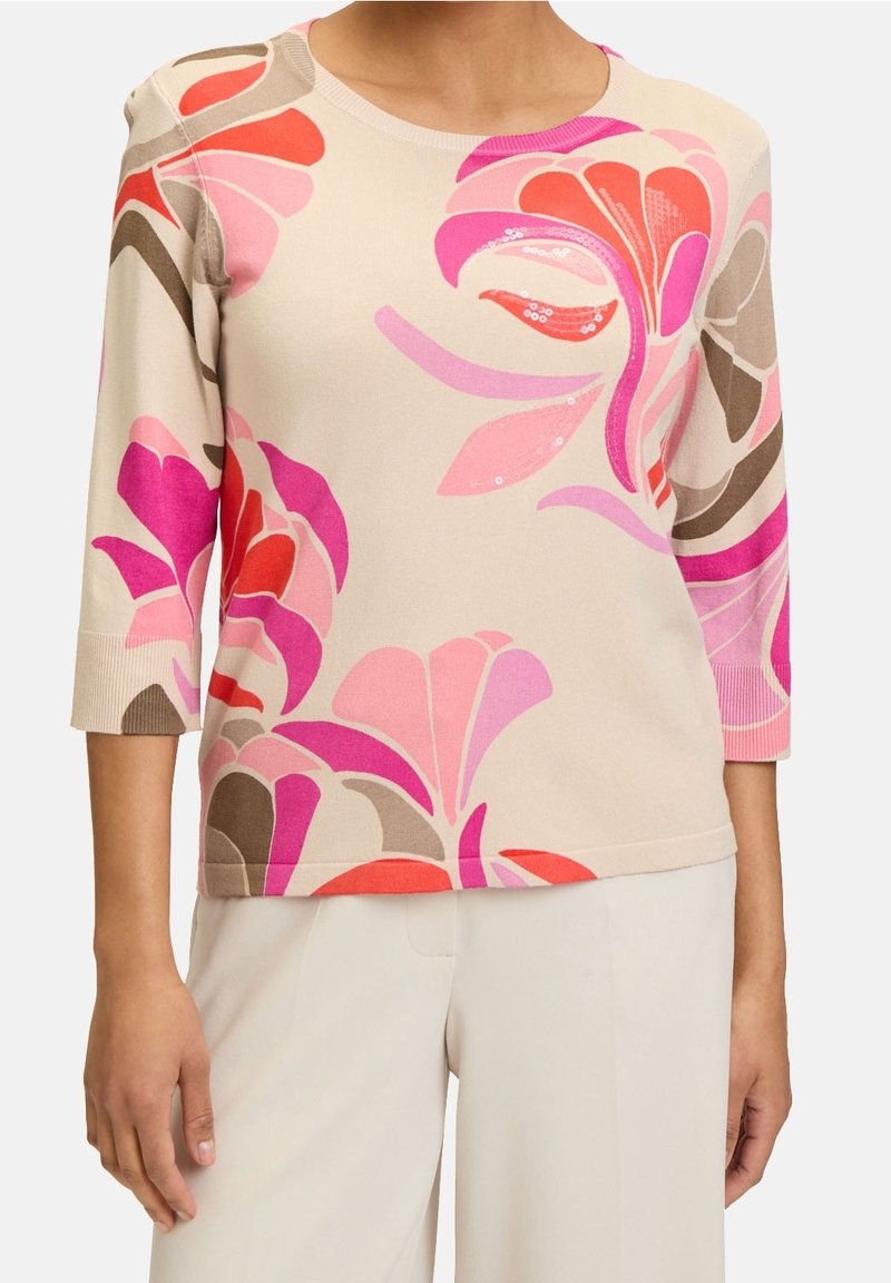 Knitted pullover in light beige with multicolored floral patterns in pink, red, and brown; features a round neck and three-quarter sleeves.