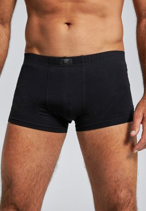 Boxers en coton noir avec une taille élastique, présentant une poche avant et une texture lisse pour le confort. Logo affiché sur la taille.